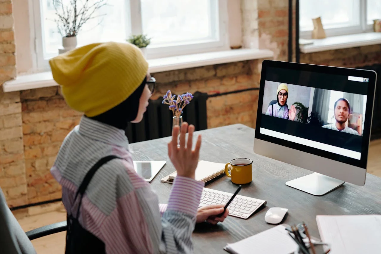 Professional staring exhausted at laptop screen surrounded by back-to-back calendar blocks